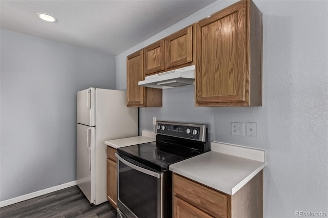 545 Tanager St, Brighton, CO 80601 - kitchen with stainless steel electric stove, under cabinet range hood, dark wood-style flooring, brown cabinets, and light countertops