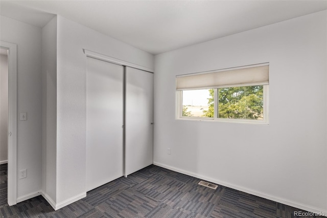545 Tanager St, Brighton, CO 80601 - unfurnished bedroom with a closet and dark carpet