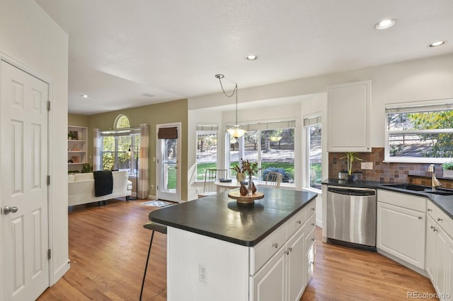 kitchen with sink, white cabinetry, dishwasher, and light wood-type flooring