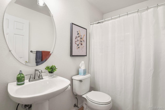 bathroom featuring toilet and sink