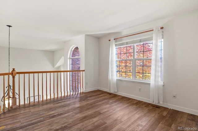 unfurnished room with dark hardwood / wood-style floors