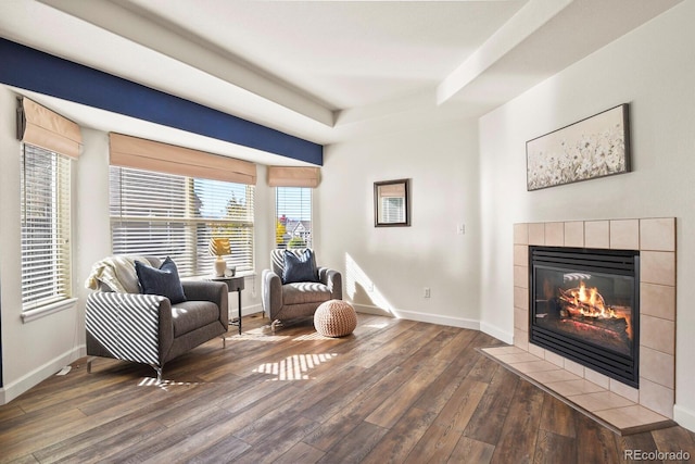 sitting room featuring dark hardwood / wood-style flooring and a tile fireplace