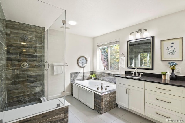 bathroom featuring vanity, tile patterned floors, and separate shower and tub