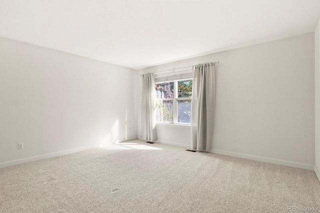 unfurnished room with light carpet