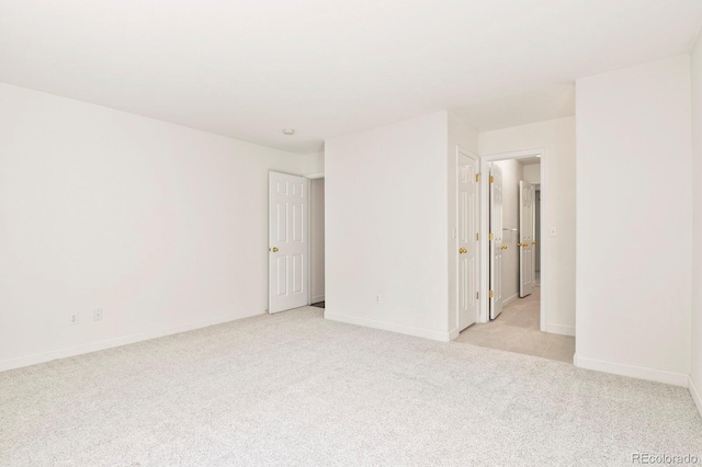 unfurnished room with light colored carpet