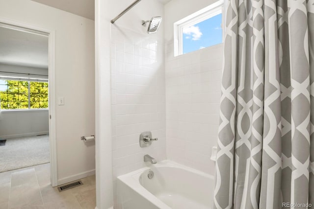 bathroom with tile patterned floors and shower / tub combo