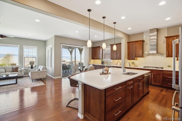 10731 Featherwalk Ln, Highlands Ranch, CO 80126 - kitchen with a sink, wall chimney exhaust hood, light countertops, dark wood-style flooring, and a kitchen breakfast bar