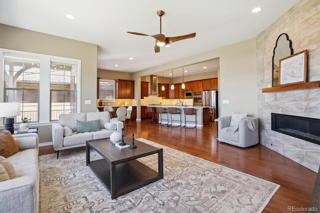 10731 Featherwalk Ln, Highlands Ranch, CO 80126 - living room with ceiling fan, wood finished floors, a tile fireplace, and recessed lighting