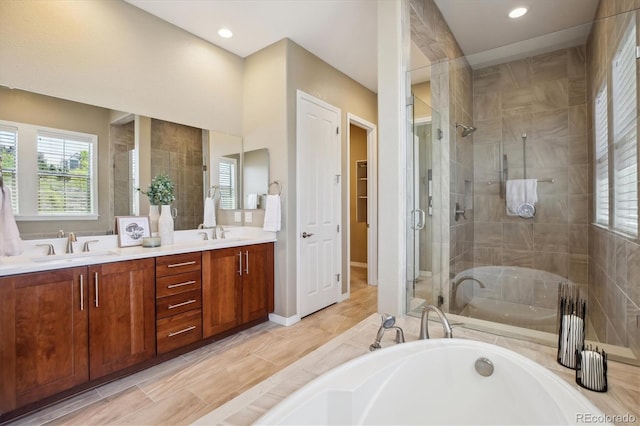 10731 Featherwalk Ln, Highlands Ranch, CO 80126 - full bathroom featuring a bath, a shower stall, double vanity, and recessed lighting