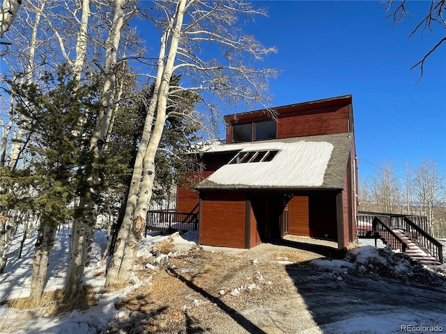 snow covered property featuring a deck