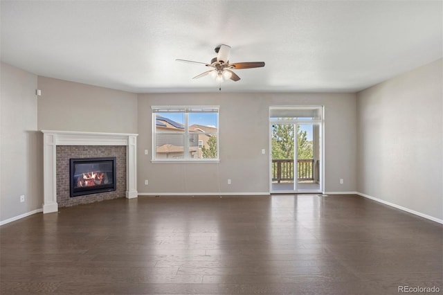12210 Pine Post Dr, Parker, CO 80138 - unfurnished living room featuring ceiling fan, dark wood-type flooring, a tile fireplace, and baseboards