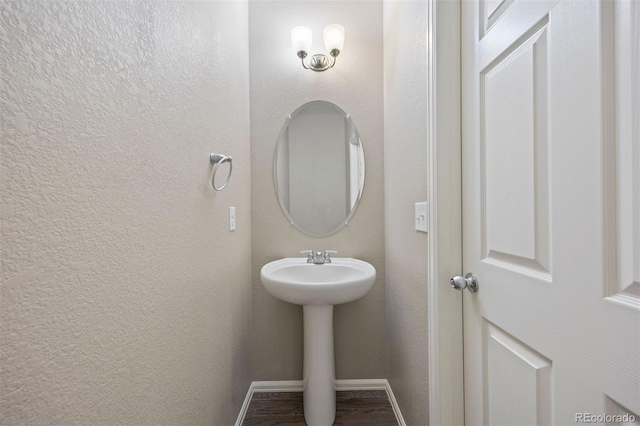 12210 Pine Post Dr, Parker, CO 80138 - bathroom with baseboards, wood finished floors, a sink, and a textured wall