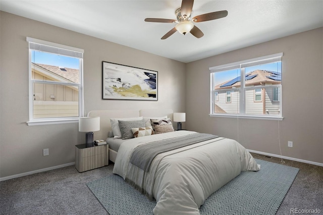 12210 Pine Post Dr, Parker, CO 80138 - carpeted bedroom featuring multiple windows, baseboards, and a ceiling fan