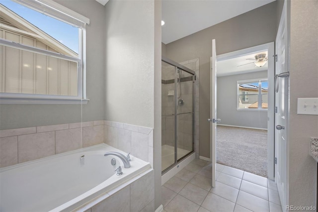 12210 Pine Post Dr, Parker, CO 80138 - full bathroom with a garden tub, a stall shower, tile patterned flooring, baseboards, and ceiling fan