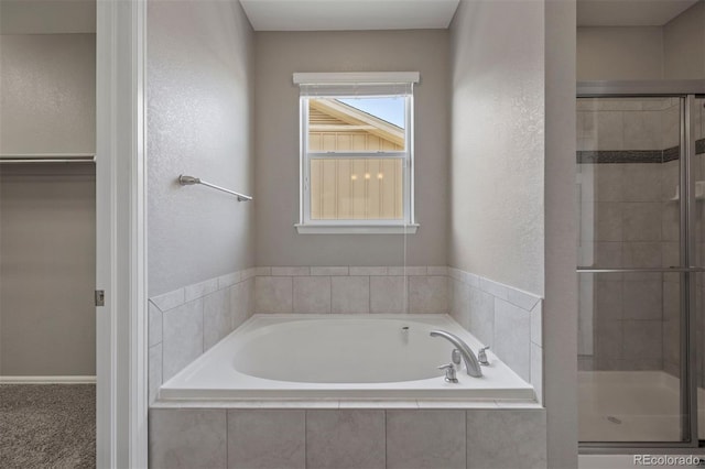 12210 Pine Post Dr, Parker, CO 80138 - bathroom with a shower stall, a bath, and a textured wall
