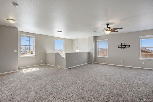 12210 Pine Post Dr, Parker, CO 80138 - carpeted spare room featuring plenty of natural light, ceiling fan, baseboards, and a smoke detector
