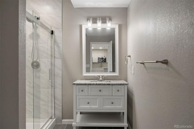 12210 Pine Post Dr, Parker, CO 80138 - full bathroom with a stall shower, vanity, and a textured wall