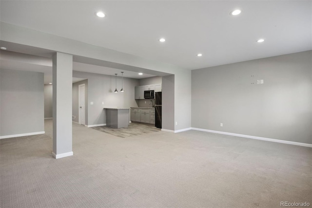 12210 Pine Post Dr, Parker, CO 80138 - unfurnished living room with light colored carpet, recessed lighting, baseboards, and bar
