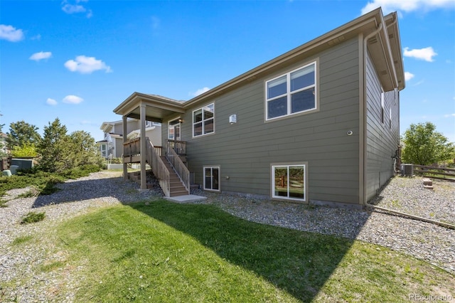 12210 Pine Post Dr, Parker, CO 80138 - rear view of property featuring a yard, stairs, and central air condition unit