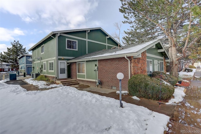 view of front facade with crawl space and brick siding