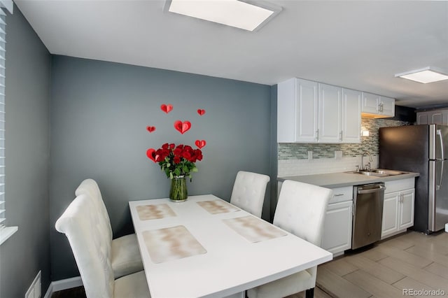 dining space with visible vents and light wood-style flooring