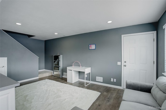 interior space featuring recessed lighting, dark wood finished floors, visible vents, and baseboards