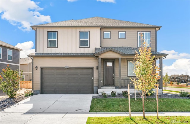 view of front of property featuring a garage and a front lawn