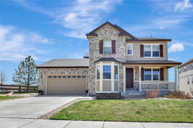 view of front of house with an attached garage, fence, a front yard, concrete driveway, and a porch