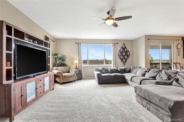 living area featuring carpet floors and a ceiling fan