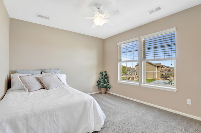 bedroom featuring visible vents, baseboards, carpet floors, and ceiling fan