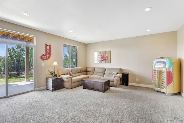 carpeted living room featuring recessed lighting and baseboards