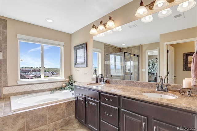 bathroom with visible vents, a sink, and a stall shower