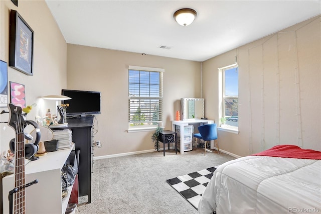 carpeted bedroom featuring baseboards, visible vents, and multiple windows