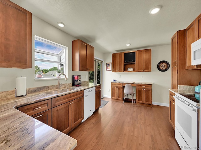 5319 E Davies Dr, Centennial, CO 80122 - kitchen with white appliances, open shelves, wood finished floors, brown cabinetry, and recessed lighting