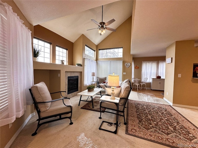 living room with high vaulted ceiling, a wealth of natural light, ceiling fan, and a fireplace