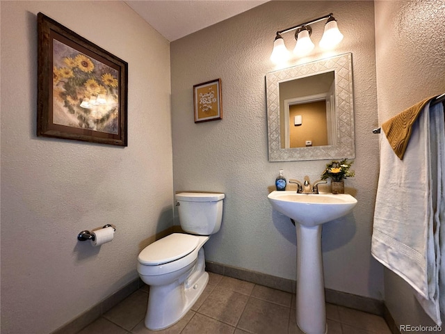 bathroom with tile patterned floors and toilet