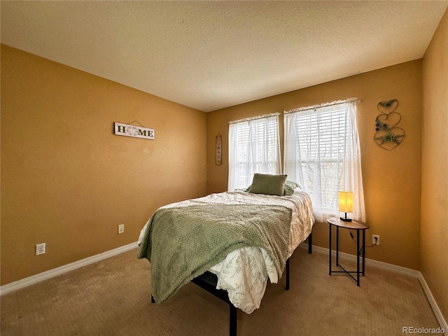 carpeted bedroom with a textured ceiling