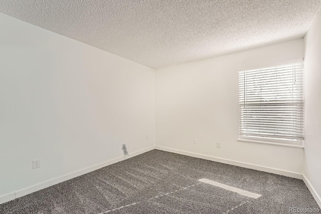 empty room featuring carpet floors and a textured ceiling