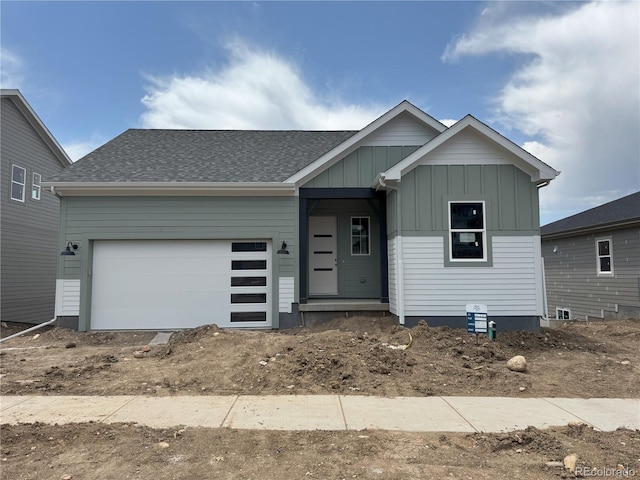 138 S Seacrest St, Golden, CO 80401 - view of front of property with board and batten siding, a garage, and a shingled roof