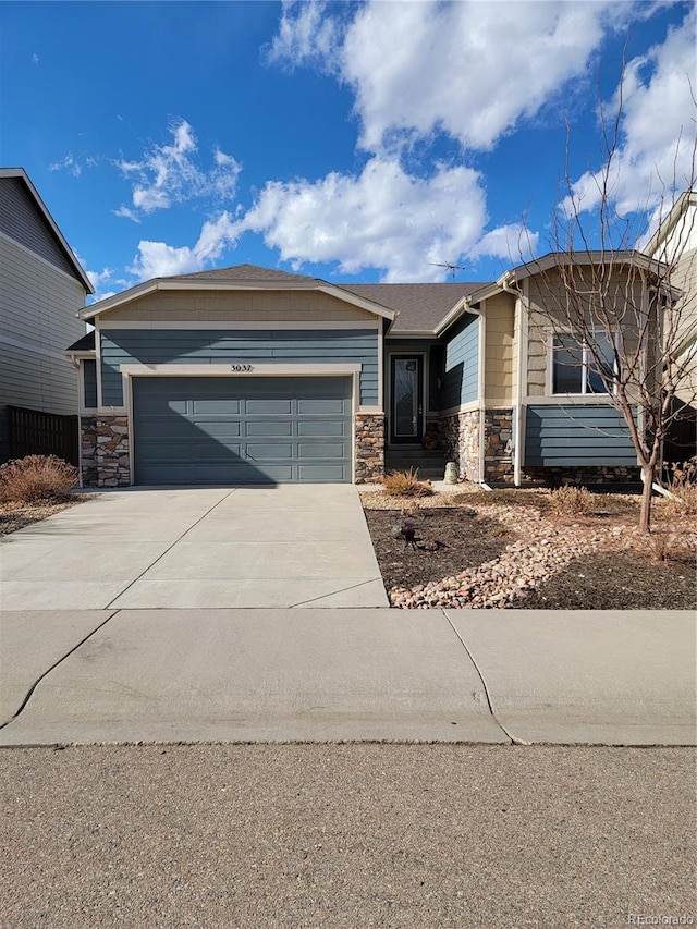 3037 Crux Dr, Loveland, CO 80537 - view of front of property with an attached garage, stone siding, and concrete driveway