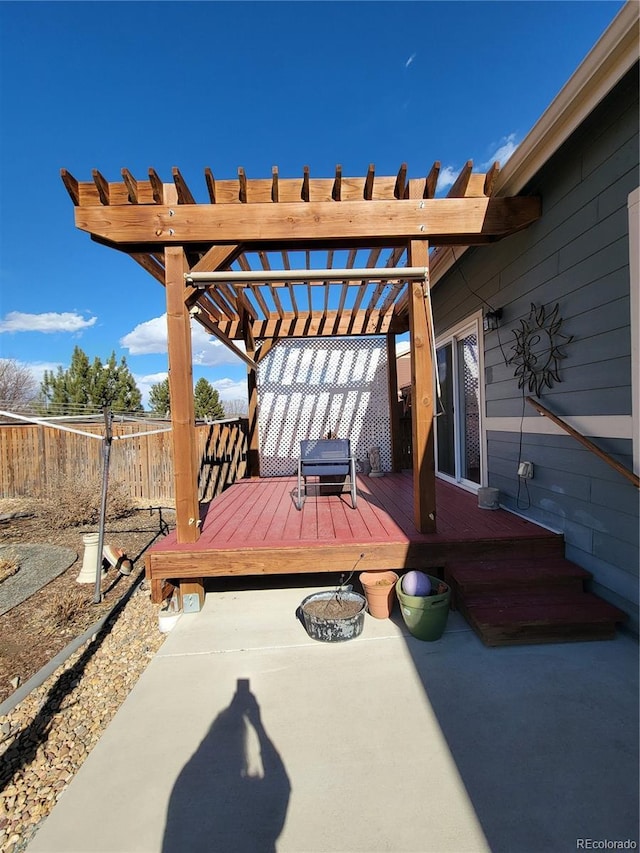 wooden terrace featuring fence and a pergola