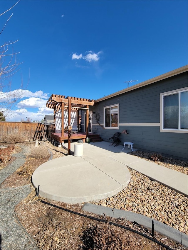 rear view of property featuring a patio, a deck, and a pergola