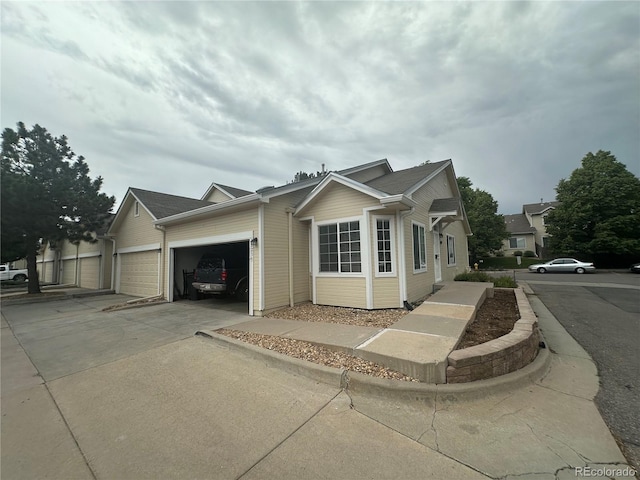 12235 E 2nd Dr, Aurora, CO 80011 - single story home with concrete driveway and a garage