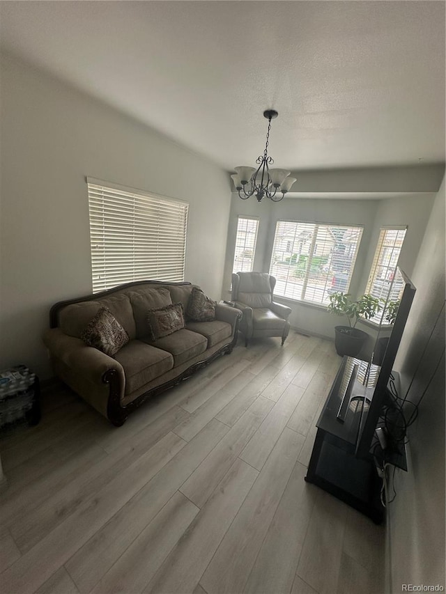 12235 E 2nd Dr, Aurora, CO 80011 - living room with a chandelier and wood finished floors
