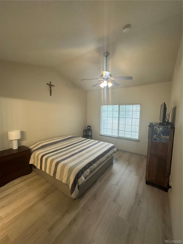 12235 E 2nd Dr, Aurora, CO 80011 - bedroom featuring wood finished floors, lofted ceiling, and ceiling fan