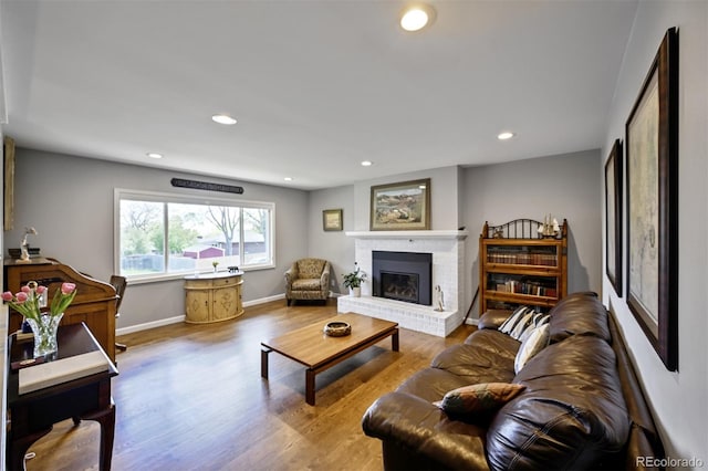 1733 S Urban Way, Lakewood, CO 80228 - living area with a brick fireplace, wood finished floors, recessed lighting, and baseboards