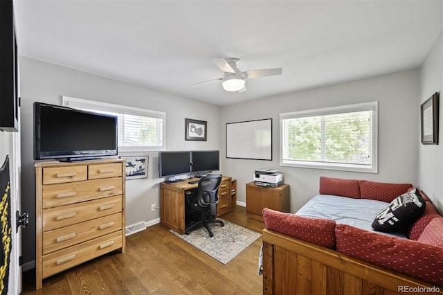 1733 S Urban Way, Lakewood, CO 80228 - bedroom featuring dark wood-type flooring, a desk, and a ceiling fan