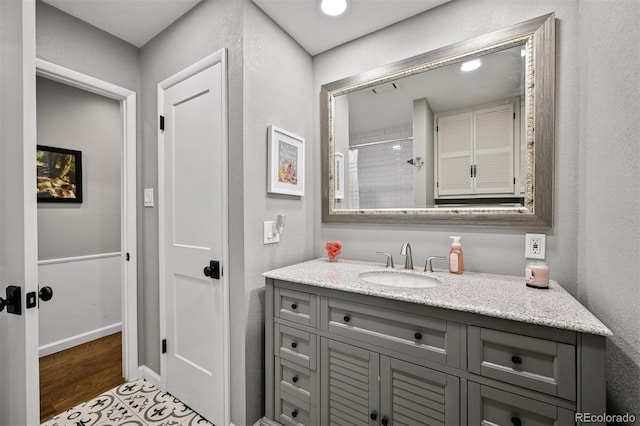 1733 S Urban Way, Lakewood, CO 80228 - bathroom featuring vanity, wood finished floors, and a textured wall