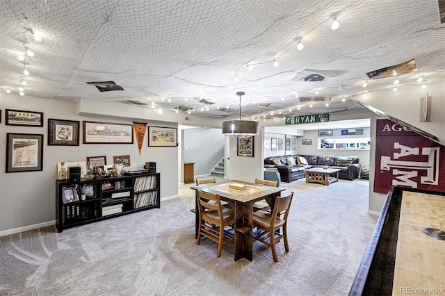 1733 S Urban Way, Lakewood, CO 80228 - carpeted dining room featuring track lighting, stairway, and baseboards