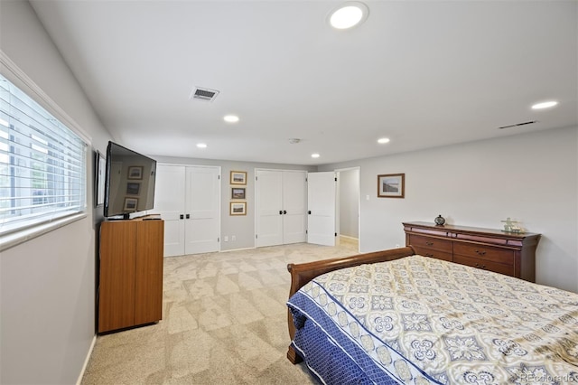 1733 S Urban Way, Lakewood, CO 80228 - bedroom featuring multiple closets, recessed lighting, light carpet, and baseboards